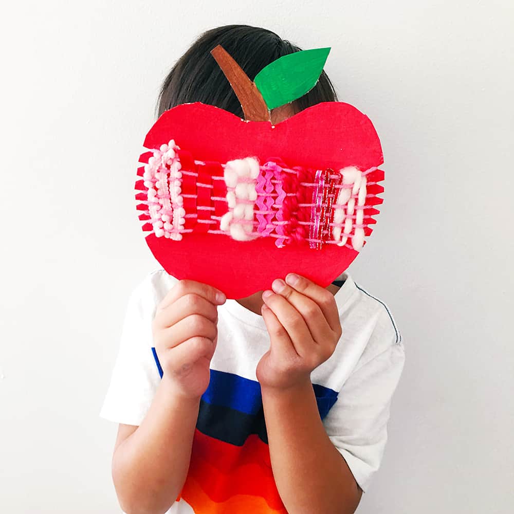 Ring in fall with an artful cardboard apple weaving craft for kids! A wonderful arts and crafts activity and fine motor skill practice. 