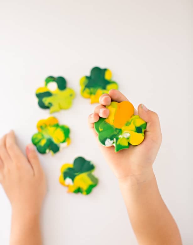 hand holding ST. PATRICK'S DAY SHAMROCK CRAYONS