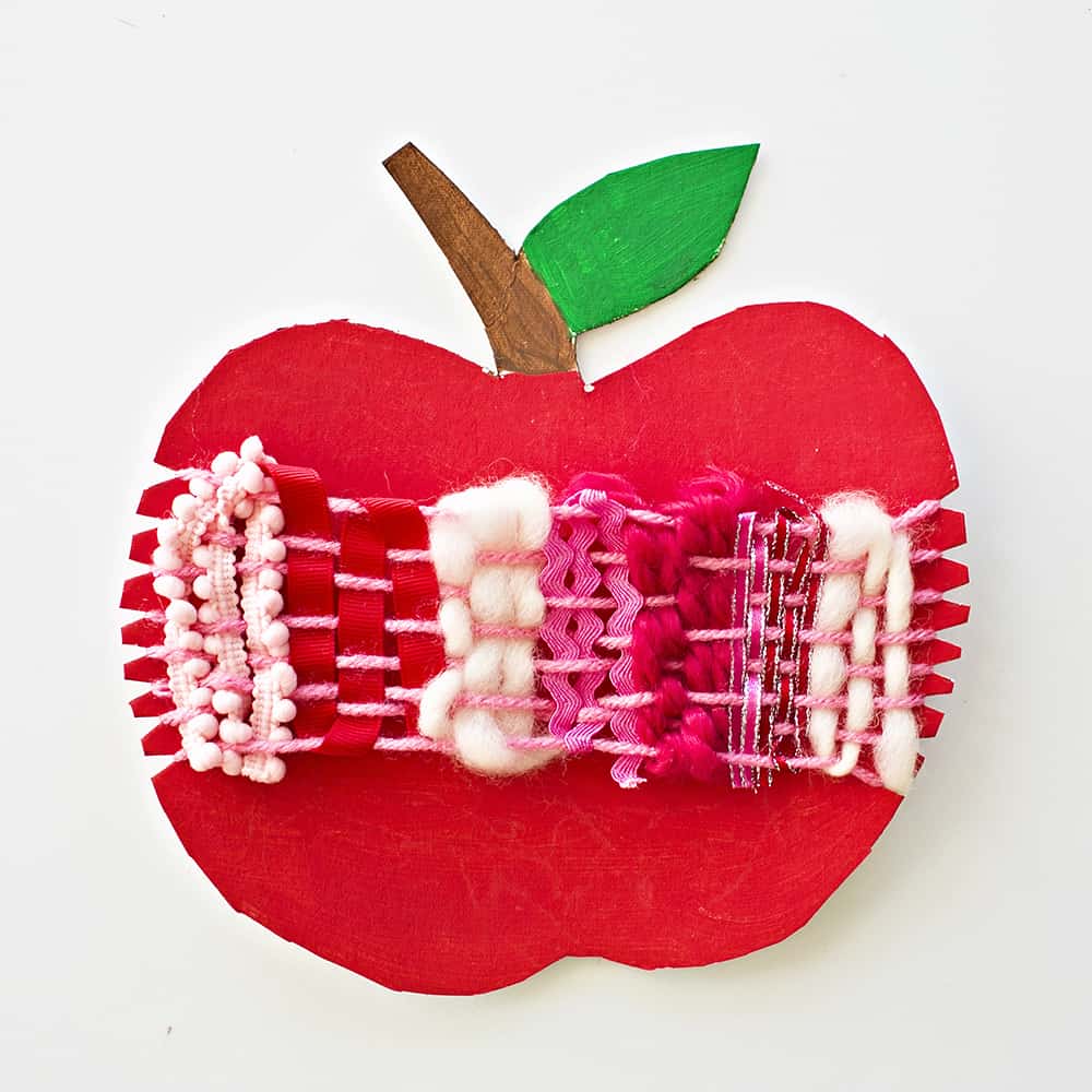 Ring in fall with an artful cardboard apple weaving craft for kids! A wonderful arts and crafts activity and fine motor skill practice. 