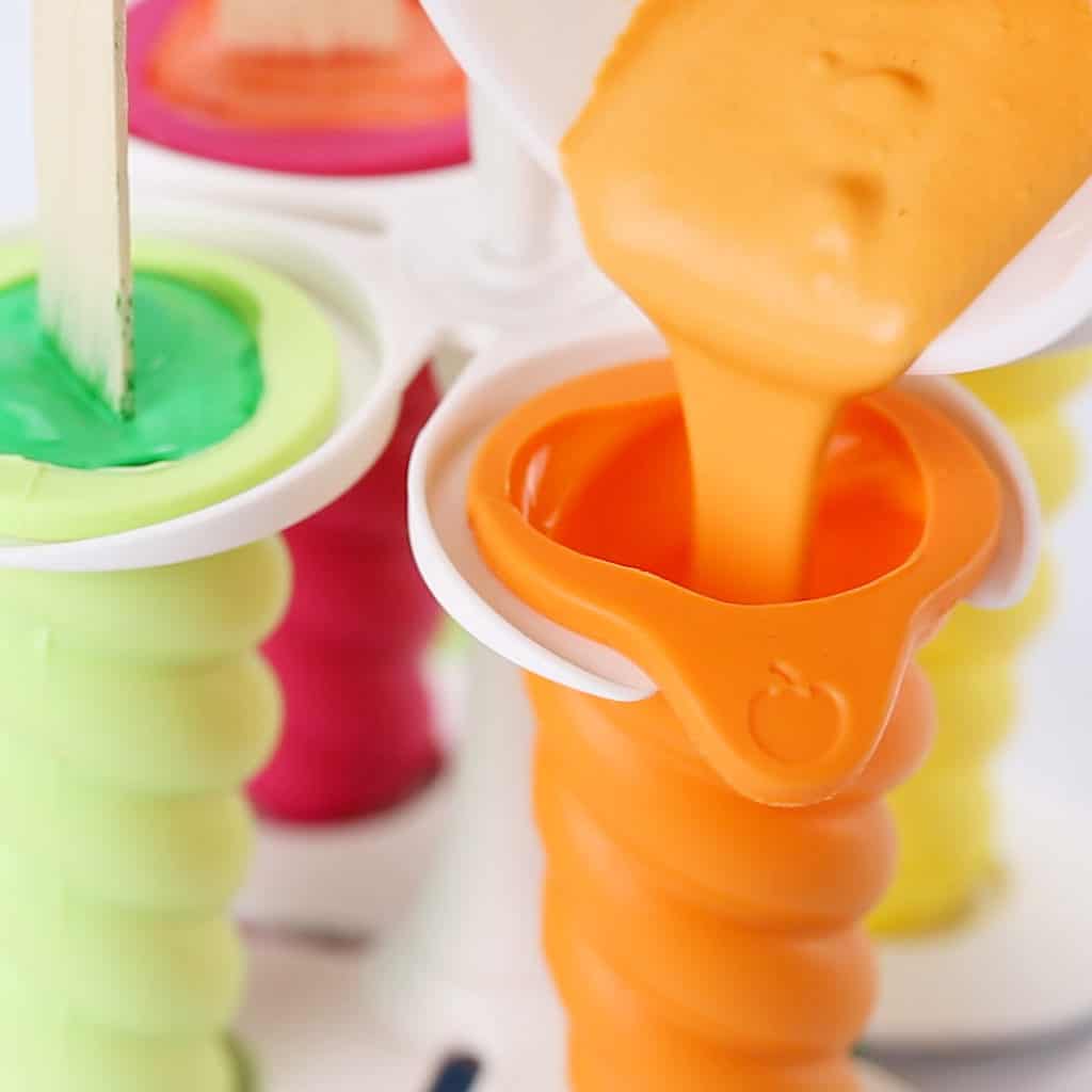 upclose of pouring DIY Sidewalk Chalk Popsicles