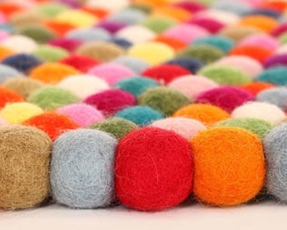 HANDCRAFTED WOOL FELT BALL RUGS FOR KIDS’ ROOMS