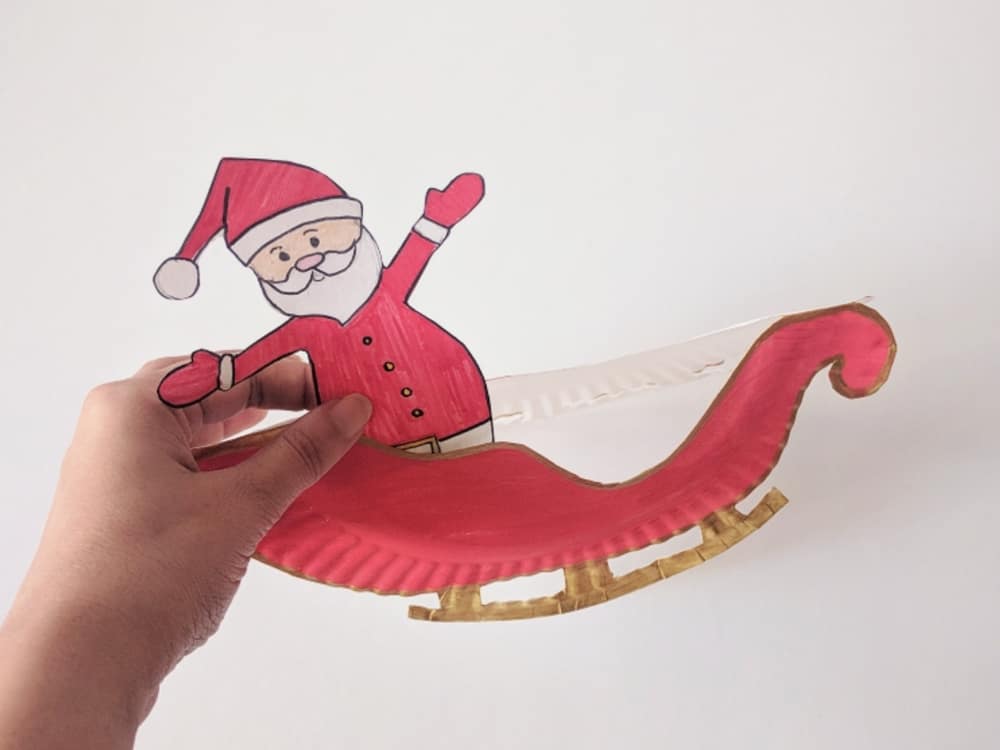 Make a rocking Santa sleigh out of a paper plate! A cute holiday craft for kids via hello, Wonderful.