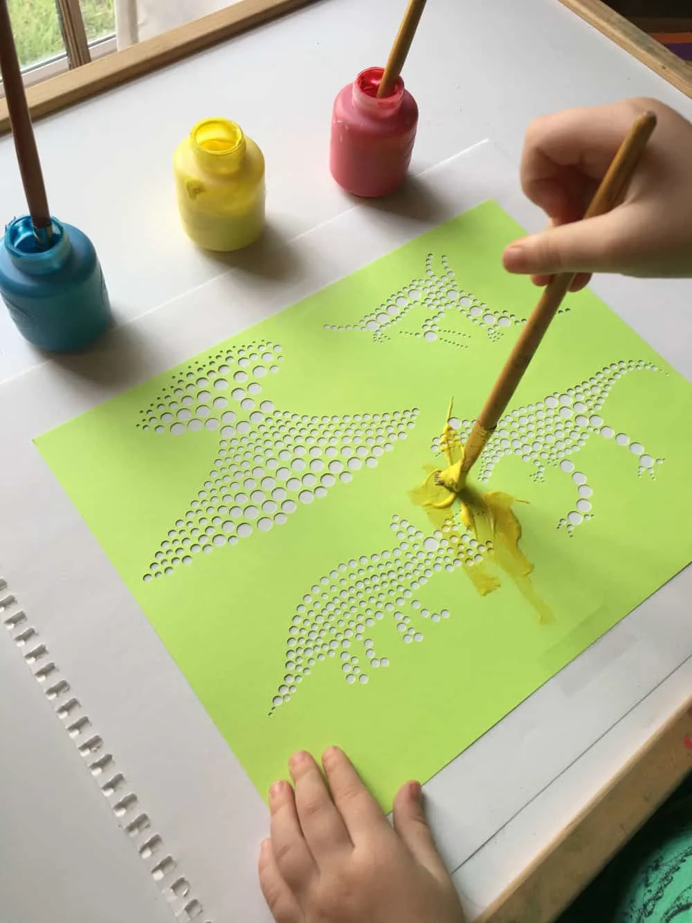 Create fun dinosaur pointillism art with a free template!