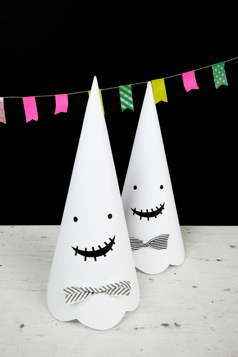 Cute Halloween paper cone ghosts (free template included).