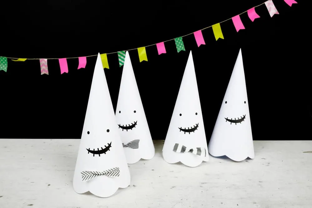 Cute Halloween paper cone ghosts (free template included).