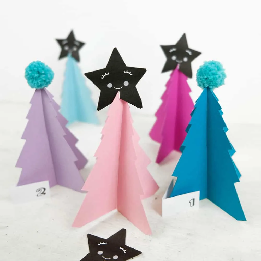 Create your own holiday countdown and use colorful pom poms to decorate these bright trees paper trees (free template included). 