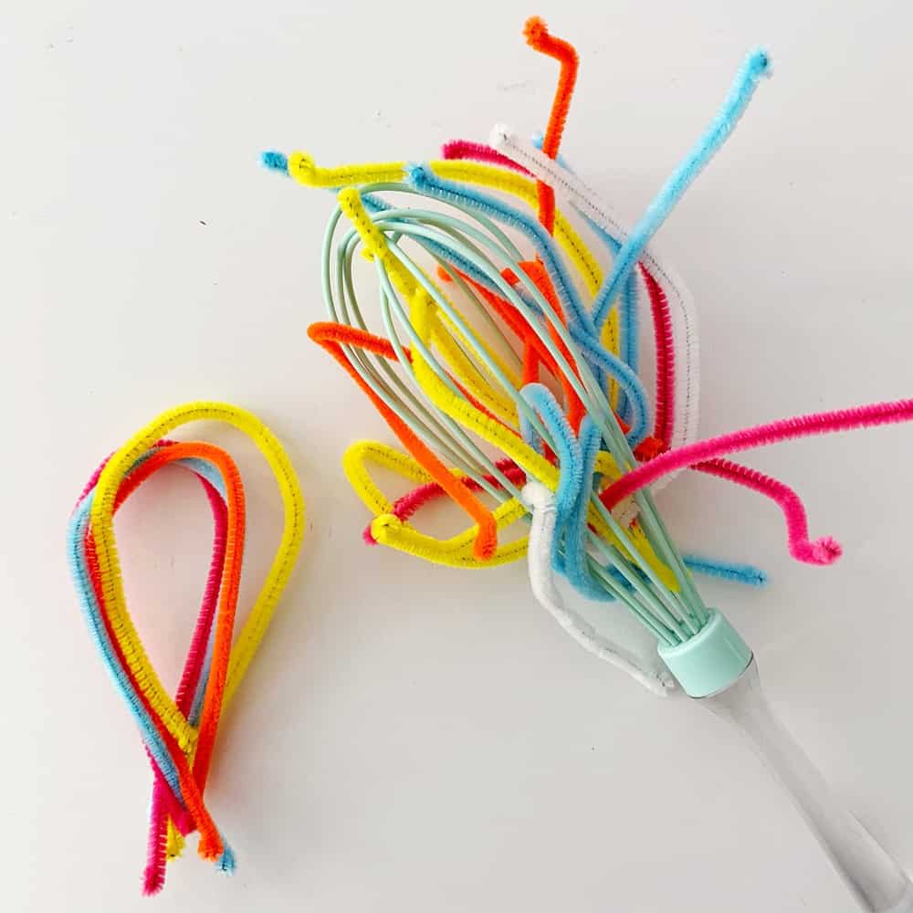 Pipe cleaner and whisk baby fine motor skills sensory activity. 