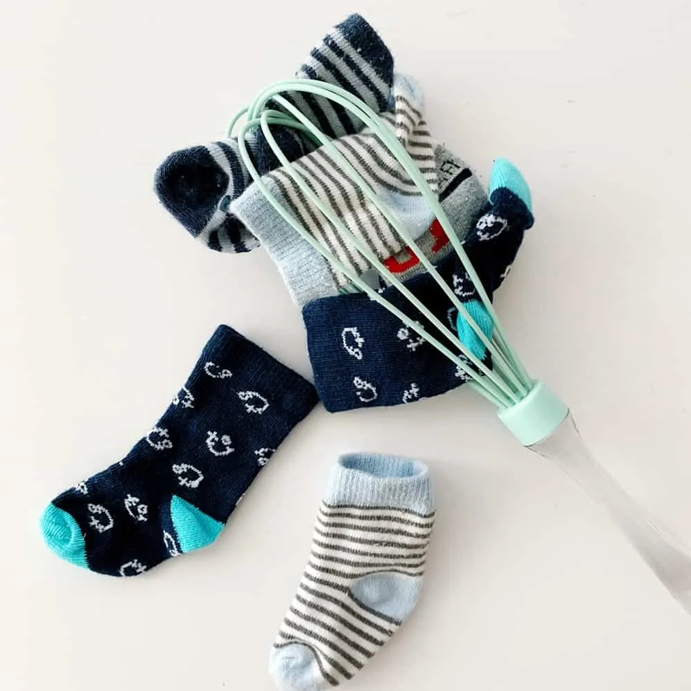 Sock and whisk baby fine motor skills sensory activity. 