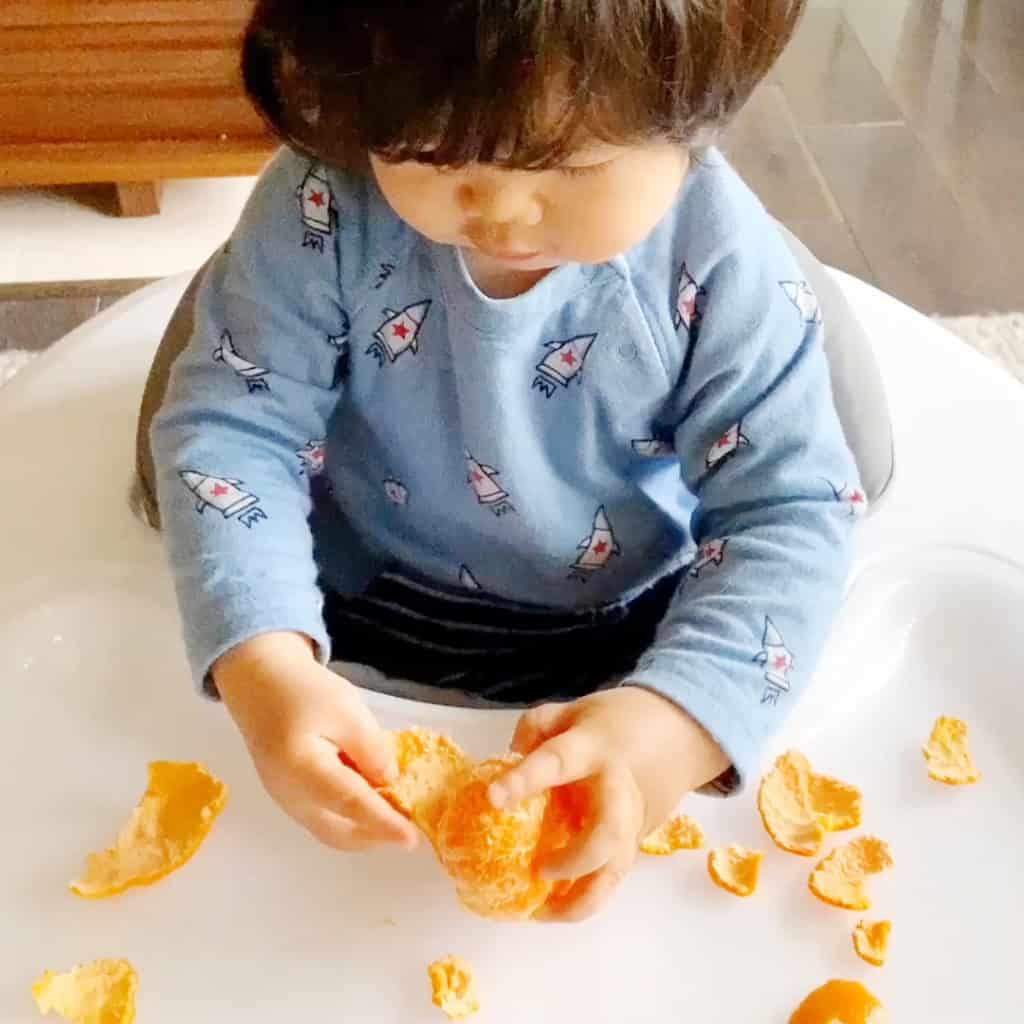 peeling oranges fine motor skills activity for babies or toddlers