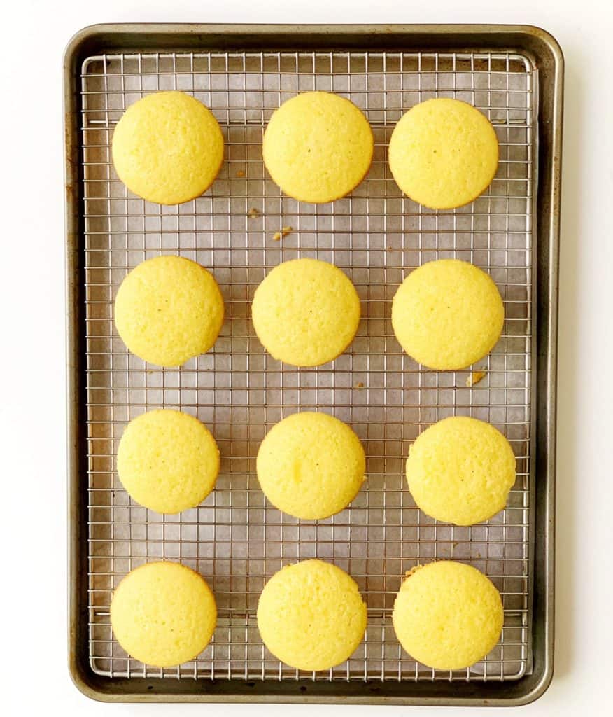 vanilla cupcakes cooling on a baking rack