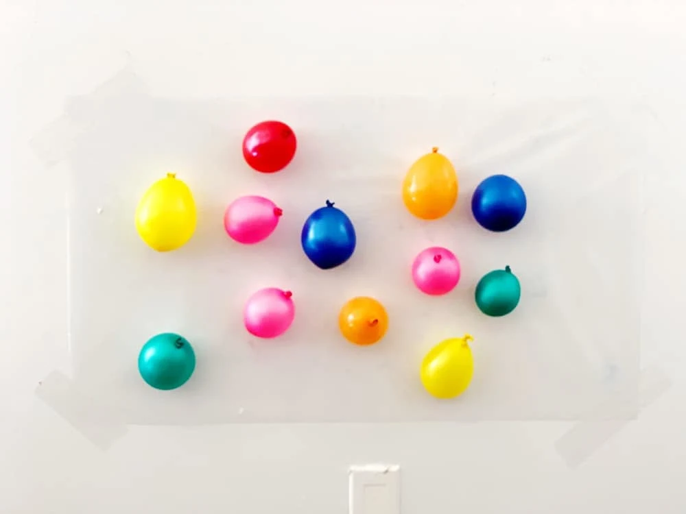 balloons on contact paper for sticky wall sensory activity