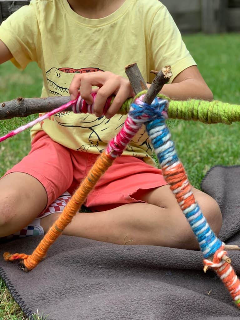 wrapping yarn around stick to make yarn letters