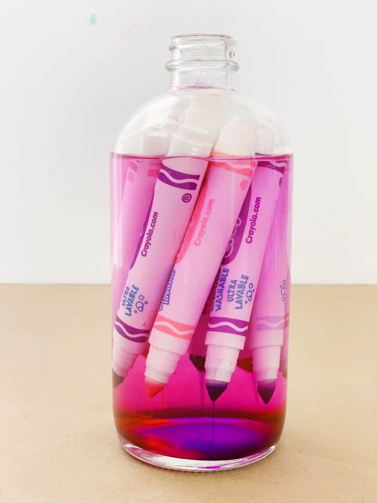 old markers in a jar filled with water to recycle into paint