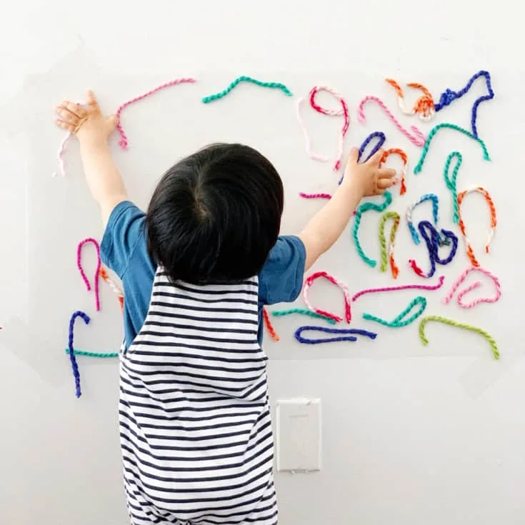 STICKY WALL YARN SENSORY ACTIVITY FOR BABIES AND TODDLERS