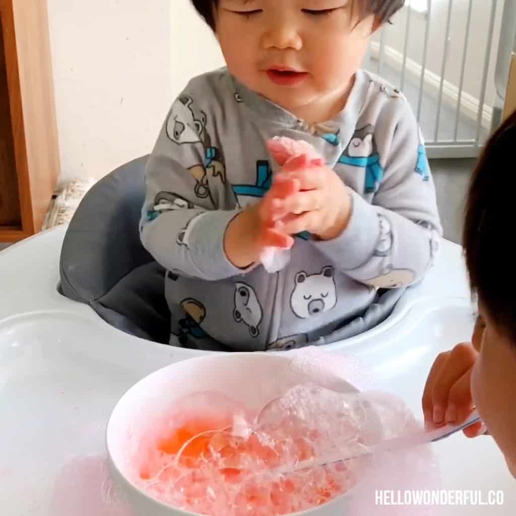 blowing bubbles sensory play 