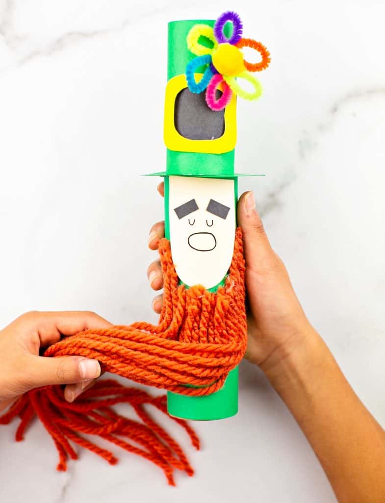 Paper tube Leprechaun craft for kids St Patrick's Day activity. Trim the leprechaun beard. 