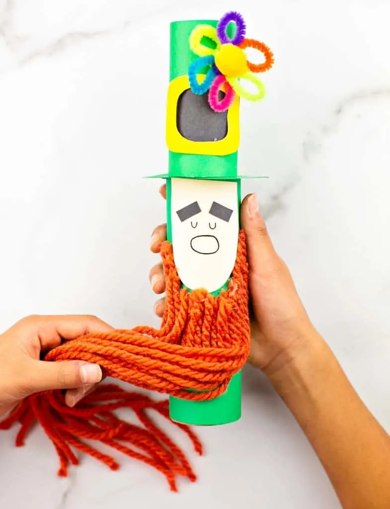 Paper tube Leprechaun craft for kids St Patrick's Day activity. Trim the leprechaun beard. 