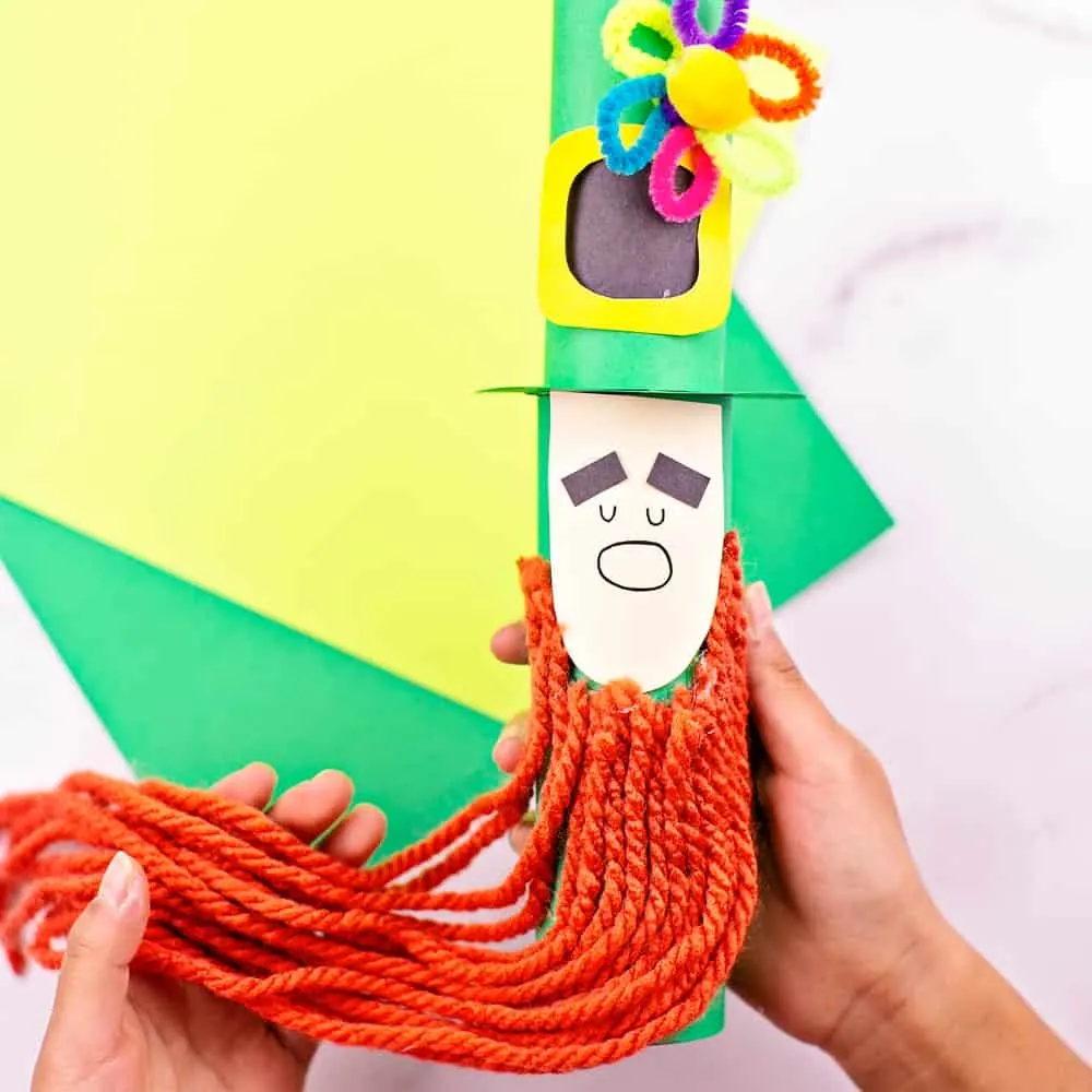 Paper tube Leprechaun craft for kids St Patrick's Day activity. Trim the leprechaun beard. 