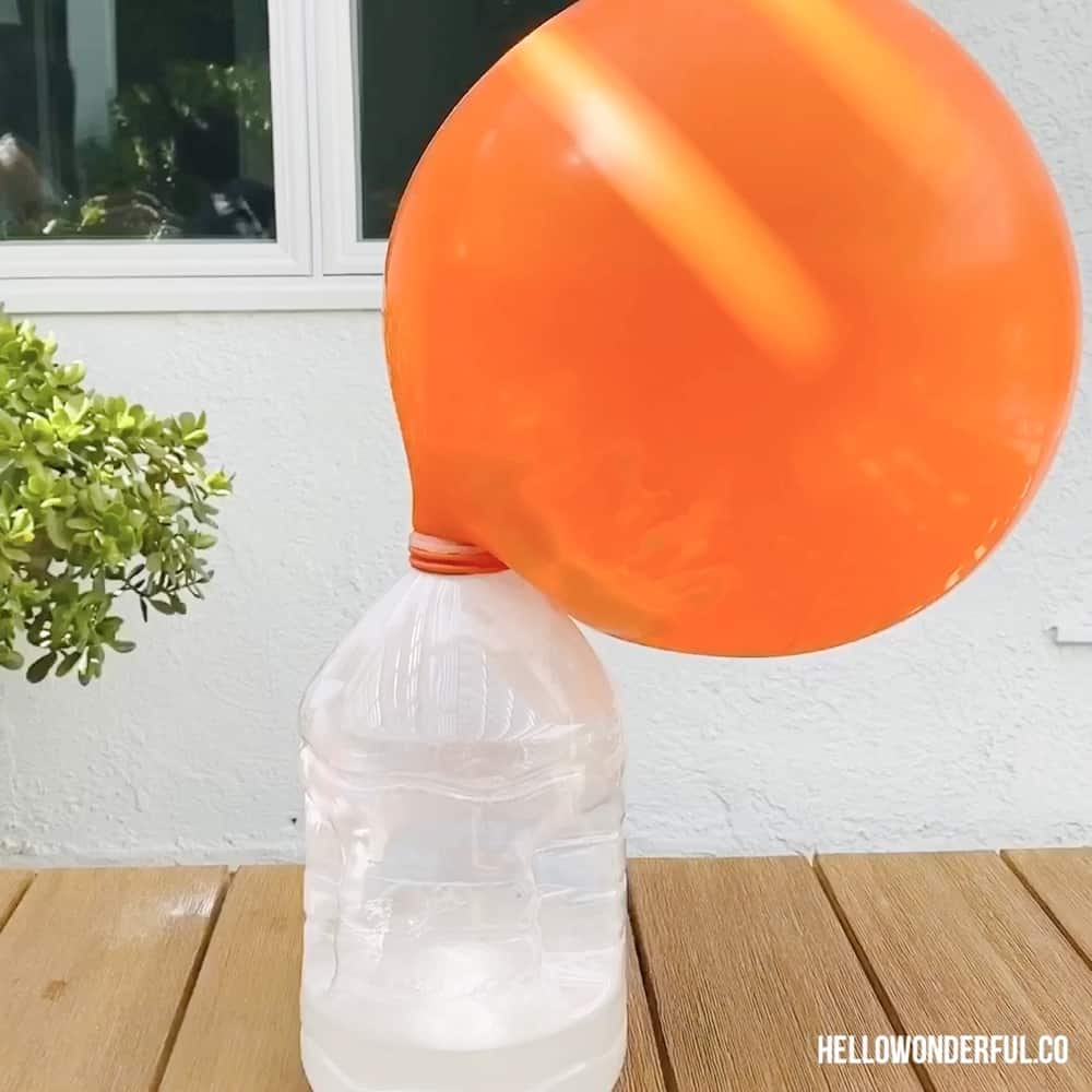 Ballon inflated over a gallon size water bottle. 