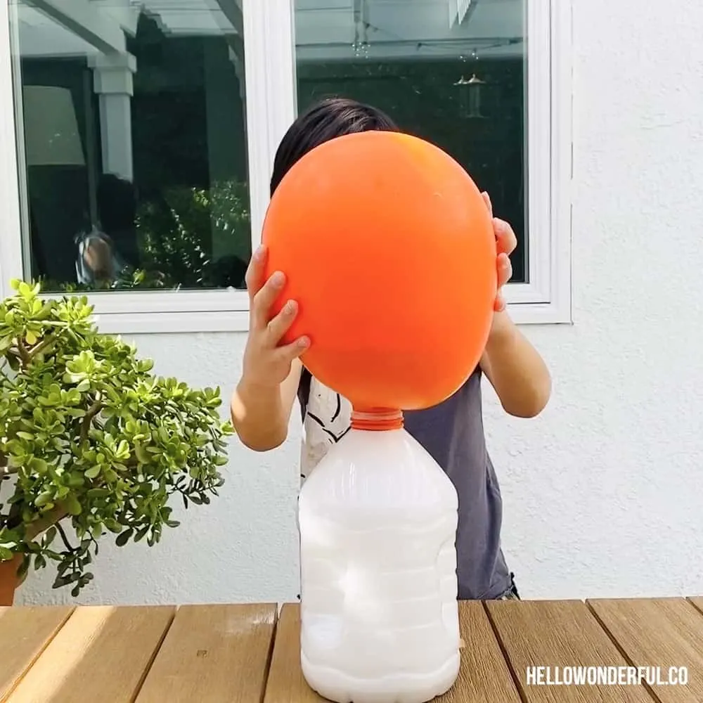 Ballon inflated over a gallon size water bottle kid science experiment