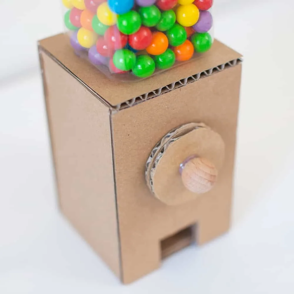 colorful gumballs inside a cardboard machine