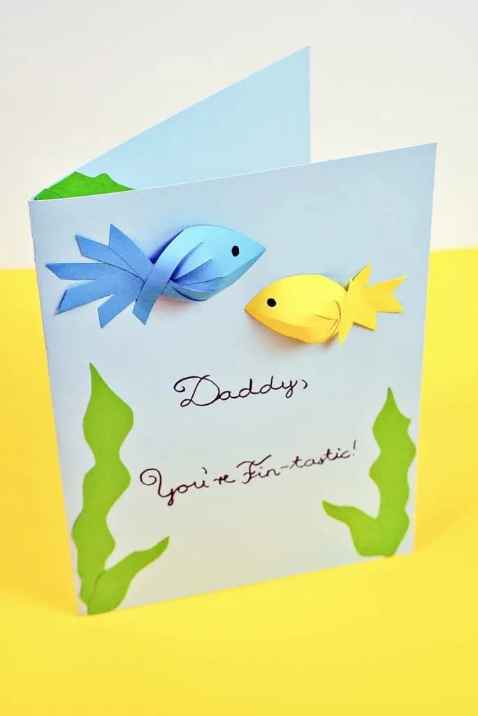 Father's Day Fish Card kids can make with showing blue and yellow paper fish. Free printable template included. 