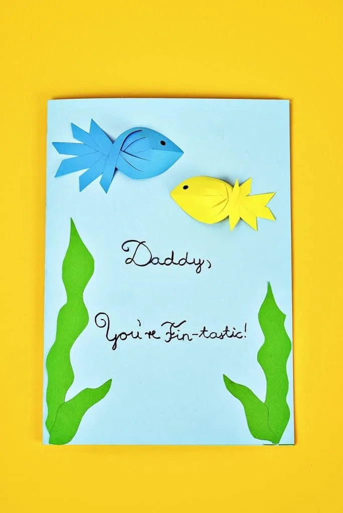 Father's Day Fish Card kids can make with showing blue and yellow paper fish. Free printable template included. 