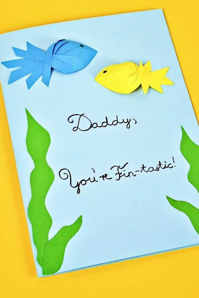 Father's Day Fish Card kids can make with showing blue and yellow paper fish. Free printable template included. 