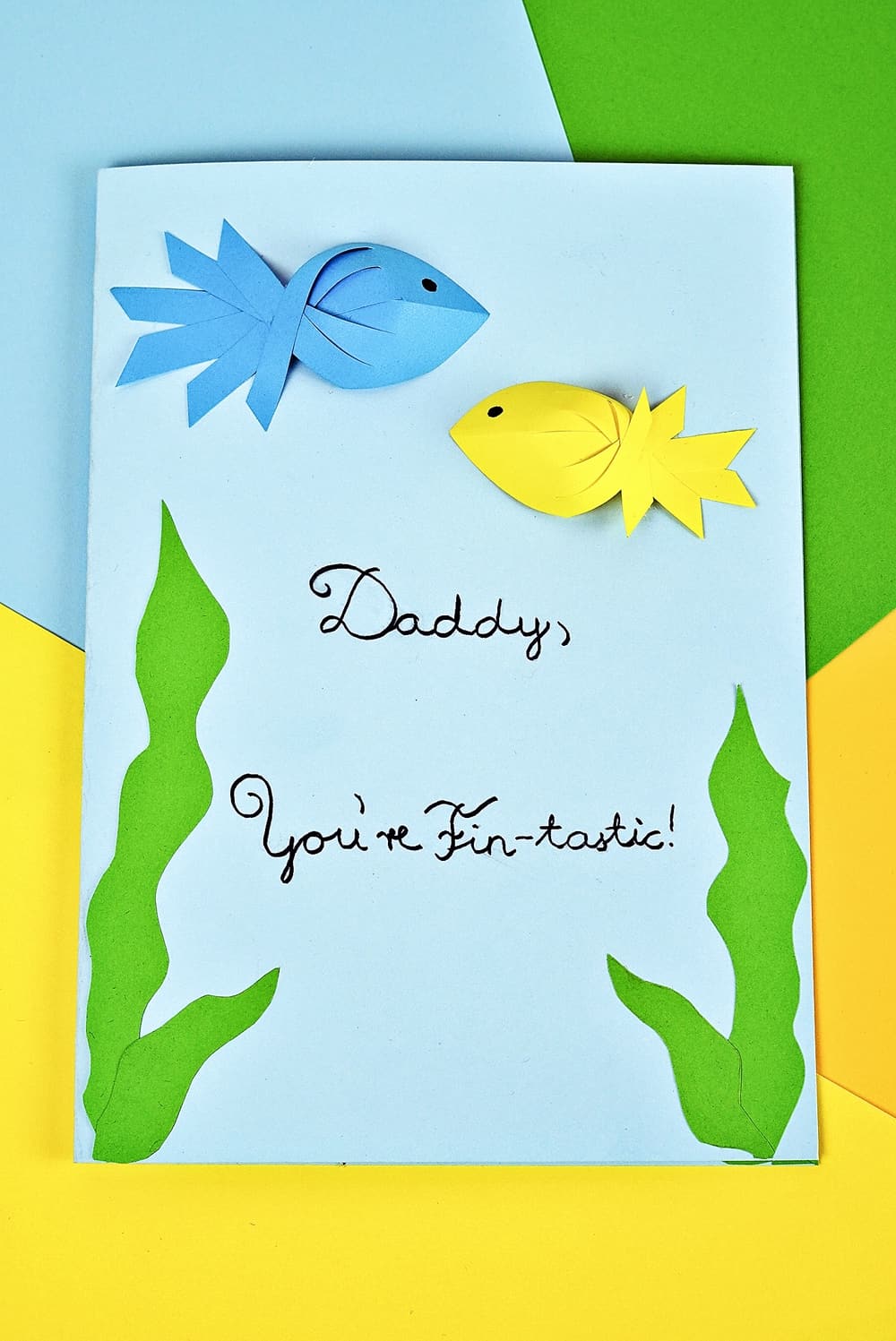 Father's Day Fish Card kids can make with showing blue and yellow paper fish. Free printable template included. 
