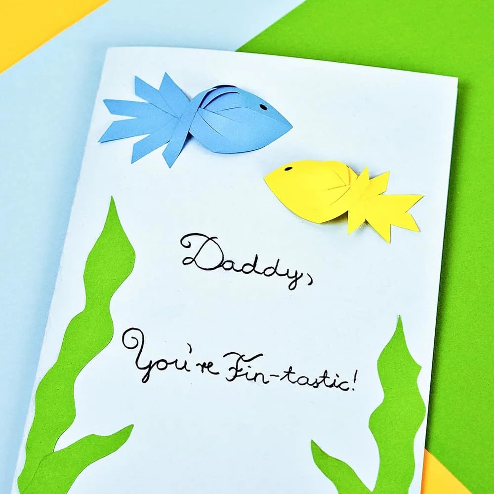 Father's Day Fish Card kids can make with showing blue and yellow paper fish. Free printable template included. 