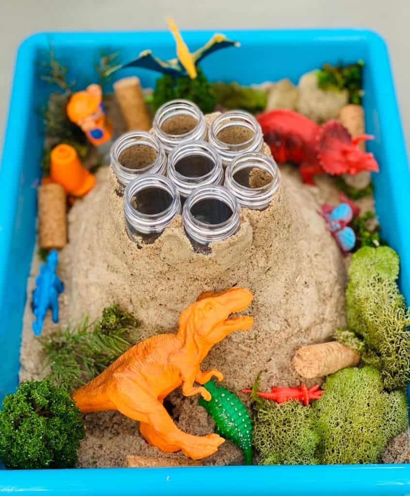 plastic test tubes around sand forming a volcano