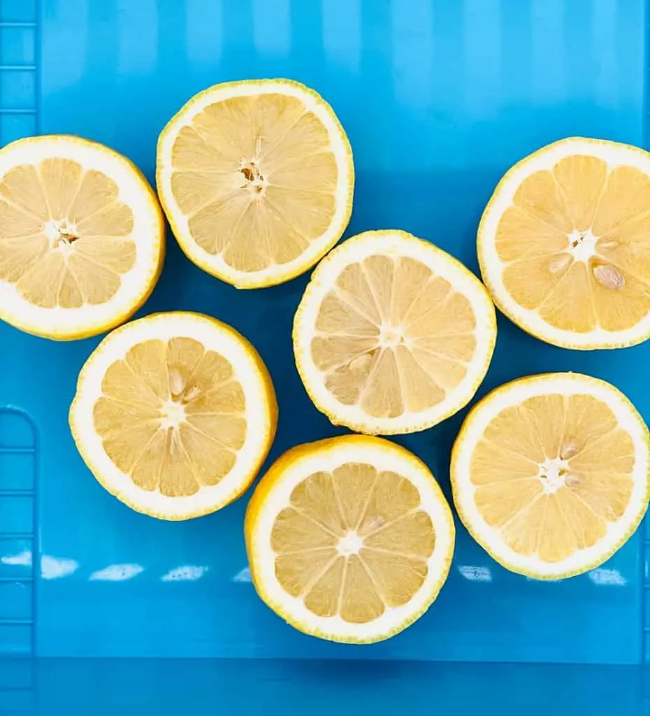 cut halved lemons inside a blue bin
