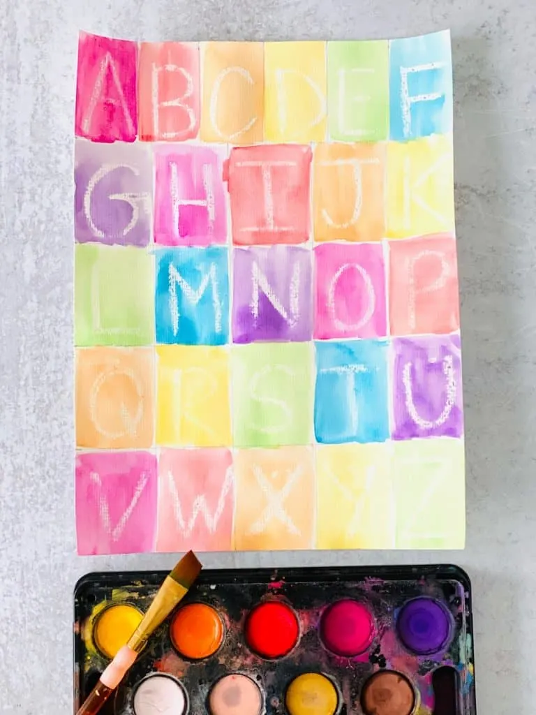 Letter learning activity for kids using crayon resist and writing out the alphabet