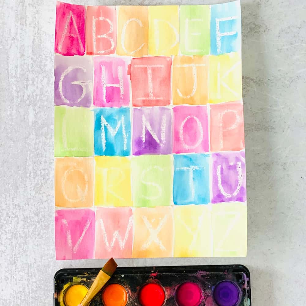 Letter learning activity for kids using crayon resist and writing out the alphabet