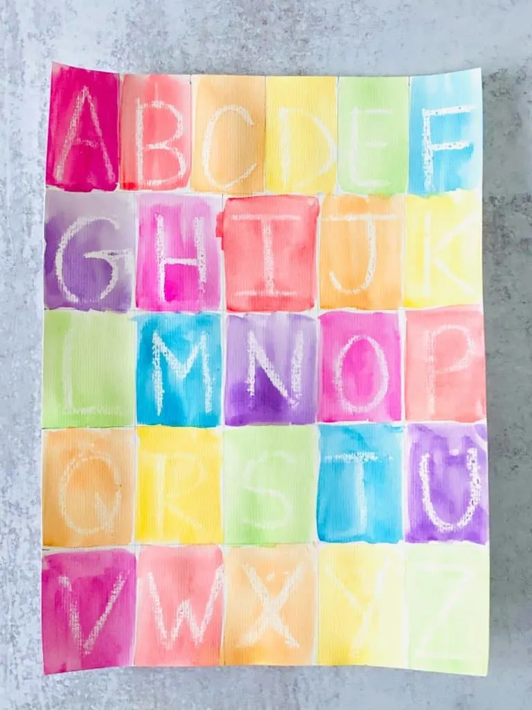 Letter learning activity for kids using crayon resist and writing out the alphabet