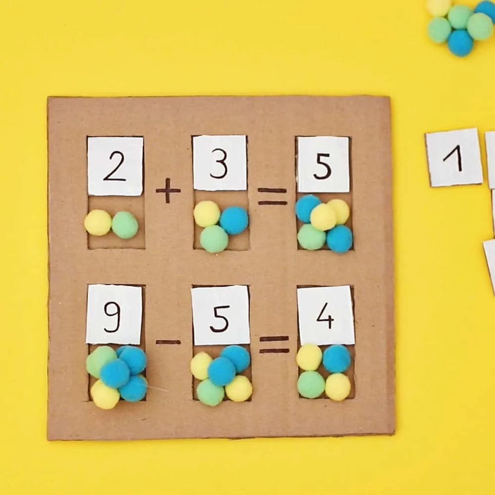 early math learning cardboard board with pom poms as counters