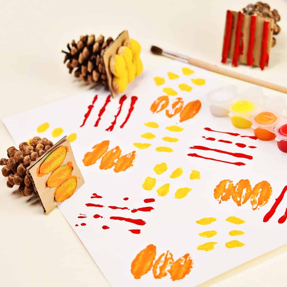 fall art stamps using pine cones and fall foliage