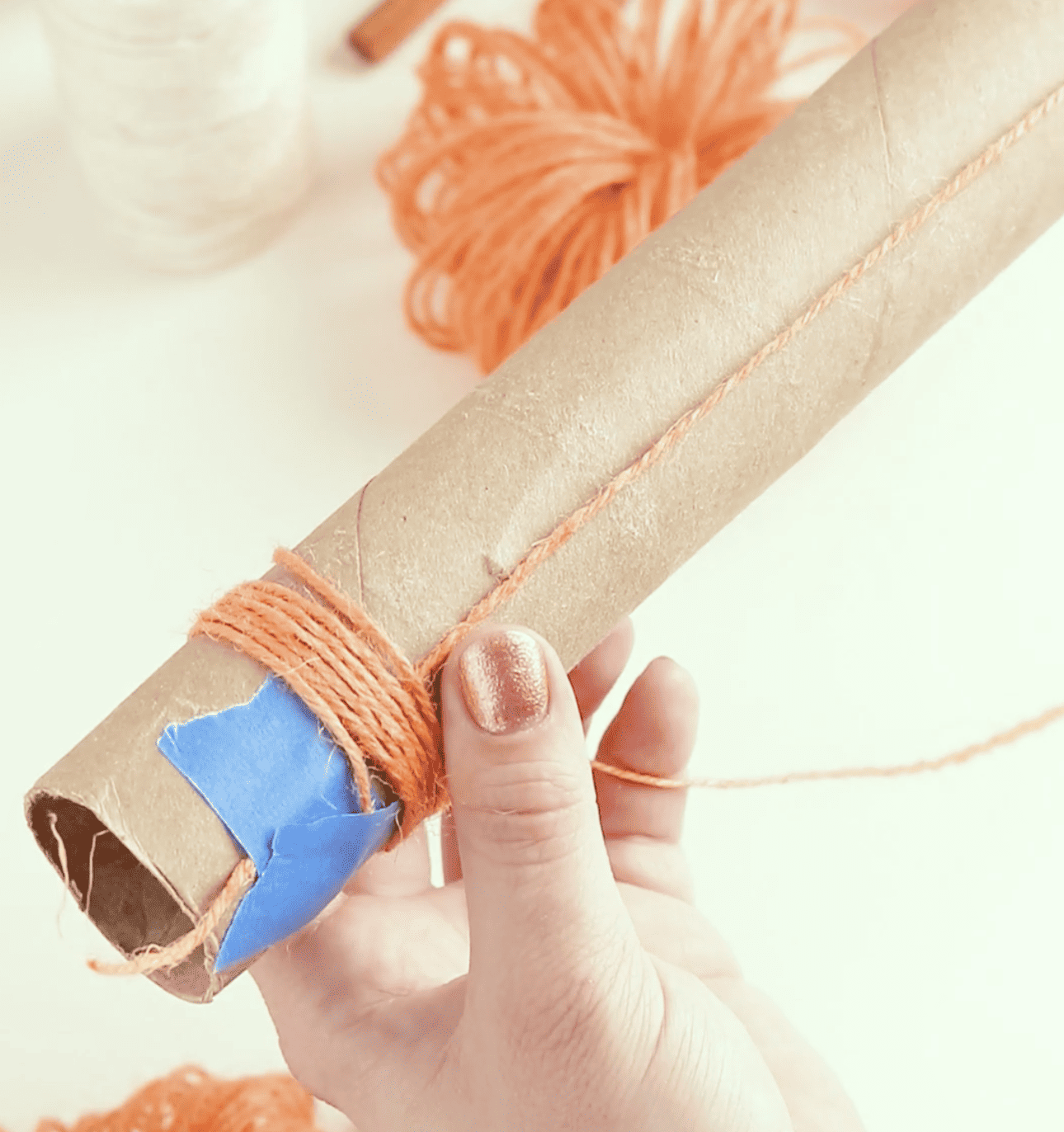 wrapping twine around paper tube