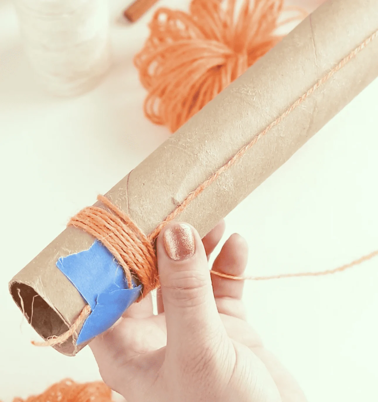 wrapping twine around paper tube